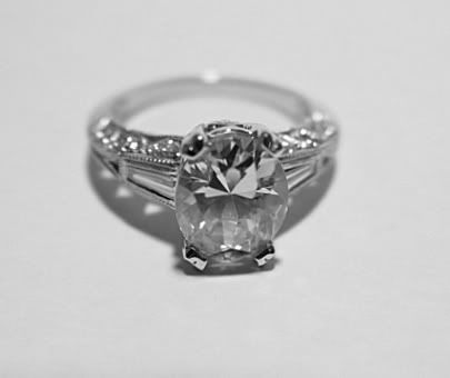 It features a center oval Cubic Zirconia measuring approx. 10 x 8 x 5 